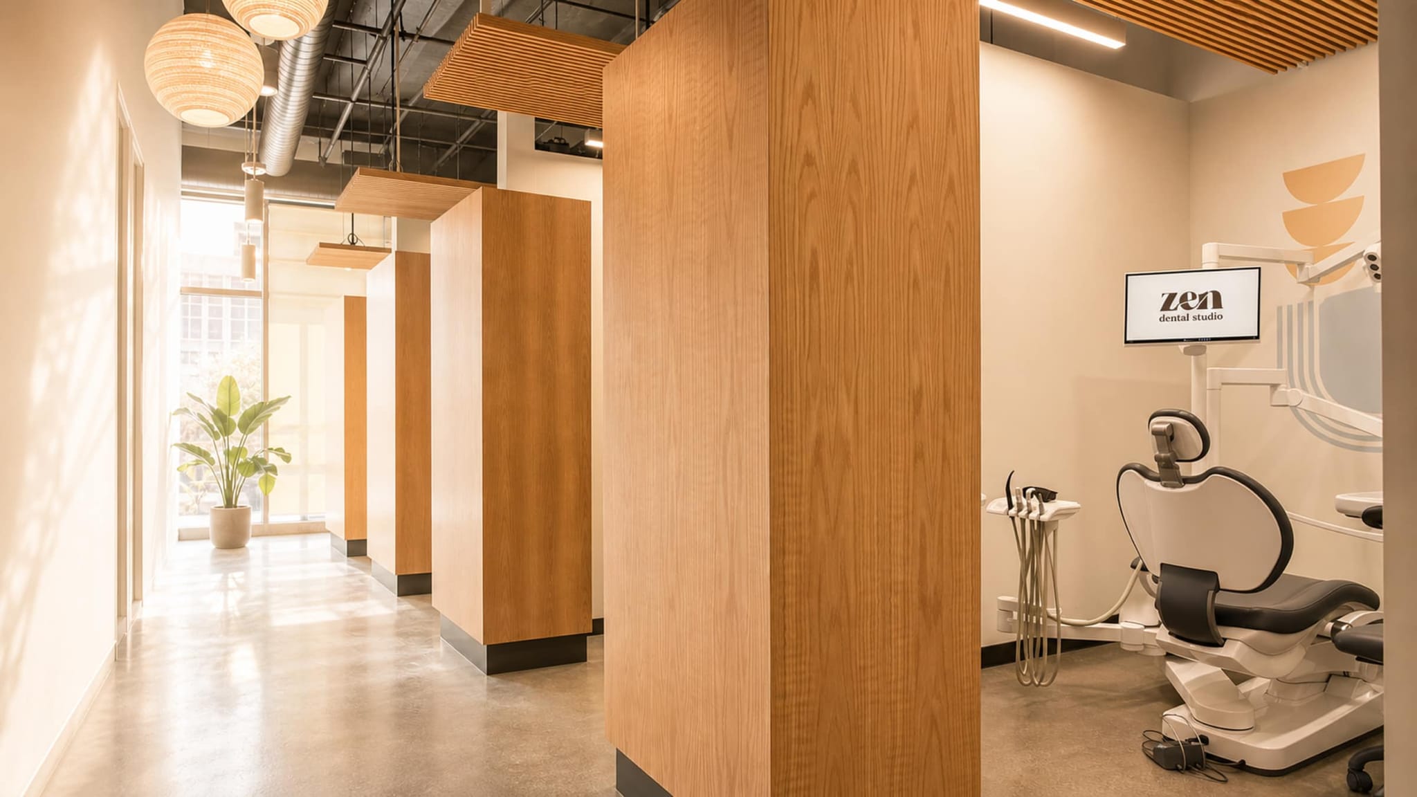 The warm, wood-lined treatment studio at Zen Dental Studio, with morning light from the windows