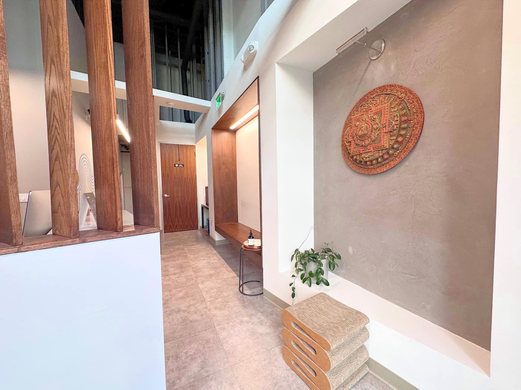 The warm SF entry, plaster, wood, and a handmade mandala